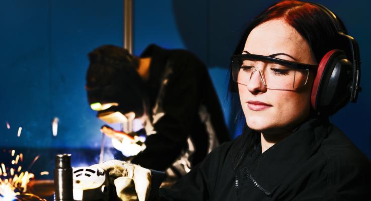 A woman welding.